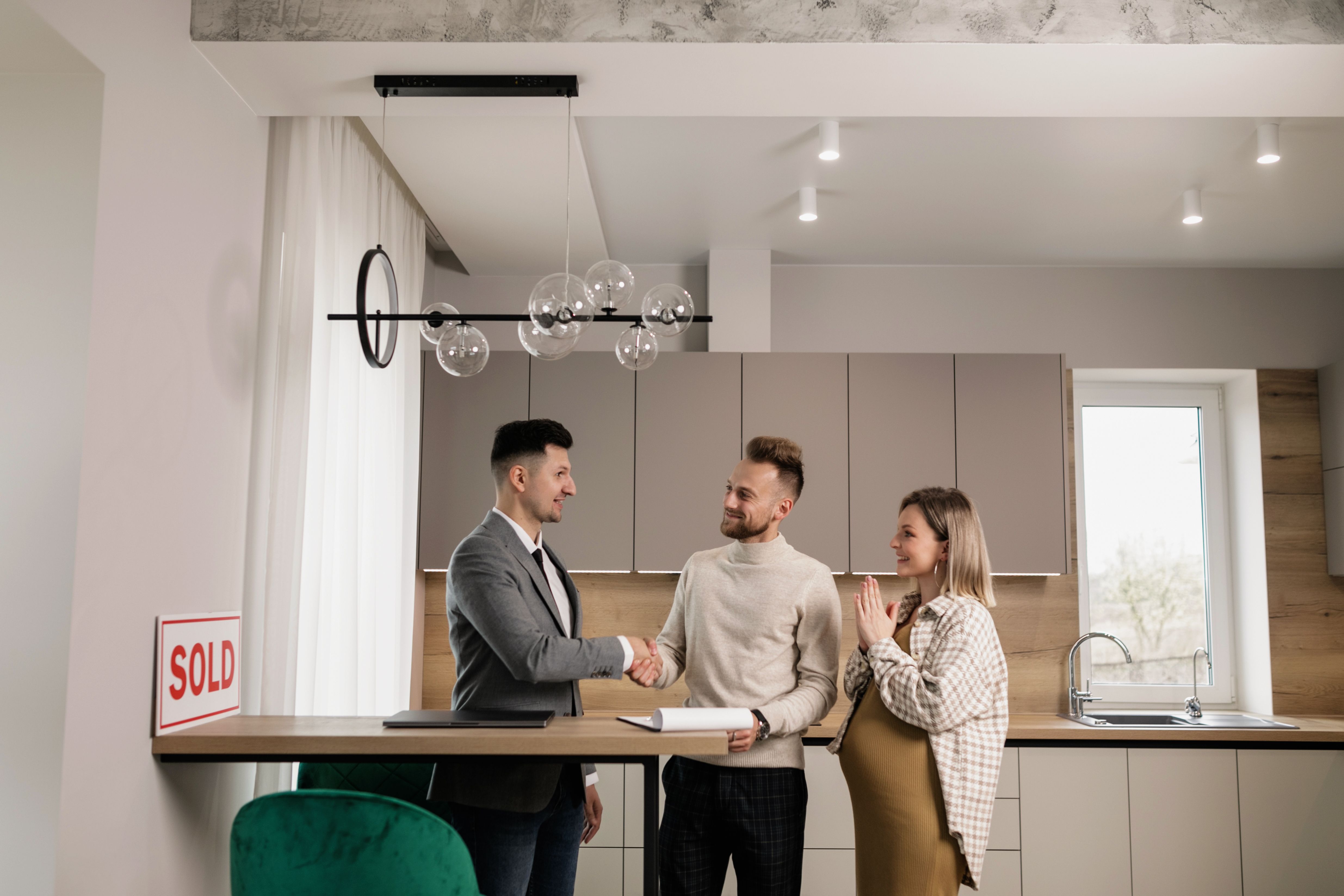 Happy homeowners holding keys